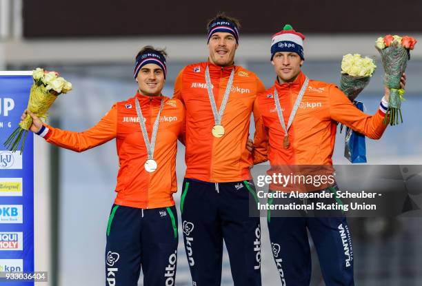 Jan Smeekens of the Netherlands, Hein Otterspeer of the Netherlands and Ronald Mulder of the Netherlands stand on the podium after the Men's 500m...