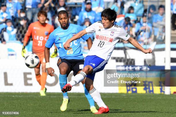 Masaru Kato of Albirex Niigata and Calvin Jong A Pin of Yokohama FC compete for the ball during the J.League J2 match between Yokohama FC and Albirex...