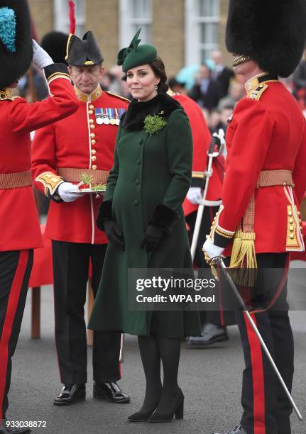 Catherine, Duchess of Cambridge presents the 1st Battalion Irish Guardsmen with shamrocks during the annual Irish Guards St Patrick's Day Parade at...