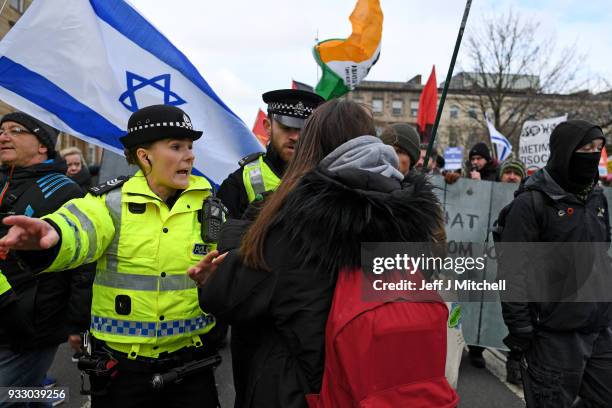 Police stand guard as Pro-Israeli and Pro Palestine demonstrators try and stop each other from marching during an anti-racism rally through the city...