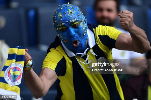 Fenerbahce fan cheers his team before the Turkish Super Lig football match between Fenerbahce and Galatasaray on March 17 at the Fenerbahce Ulker...