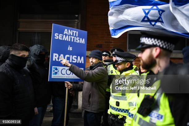 Police stand guard as Pro-Israeli and Pro Palestine demonstrators try and stop each other from marching during an anti-racism rally through the city...