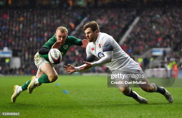 Elliot Daly of England gathers the ball ahead of Keith Earls of Ireland before going on to score his sides first try during the NatWest Six Nations...