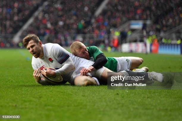 Elliot Daly of England gathers the ball ahead of Keith Earls of Ireland before going on to score his sides first try during the NatWest Six Nations...