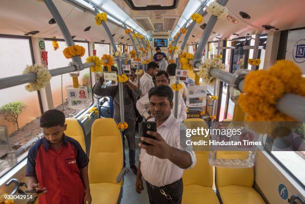 People take pictures Inside Hybrid bus after the launch of 25 Hybrid buses at Sahyadri Guest house, Walkeshwar, on March 16, 2018 in Mumbai, India....