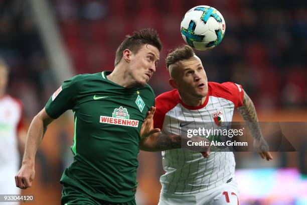 Max Kruse of Bremen (l fights for the ball with Jonathan Schmid of Augsburg during the Bundesliga match between FC Augsburg and SV Werder Bremen at...