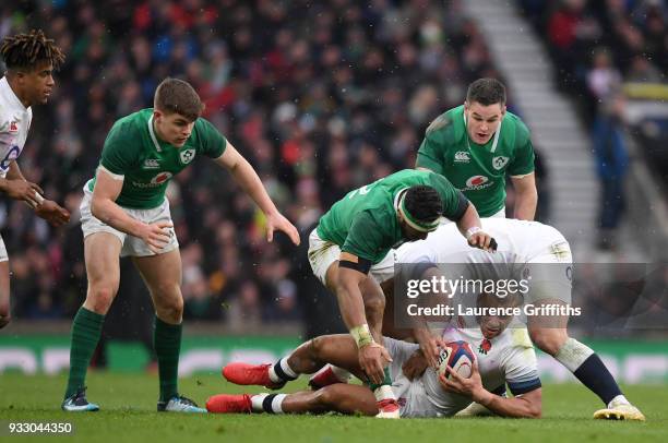 Jonathan Joseph of England with the ball is challenged by Bundee Aki of Ireland during the NatWest Six Nations match between England and Ireland at...