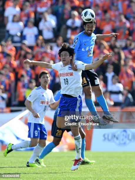Kazuhito Watanabe of Yokohama FC and Kisho Yano of Albirex Niigata compete for the ball during the J.League J2 match between Yokohama FC and Albirex...