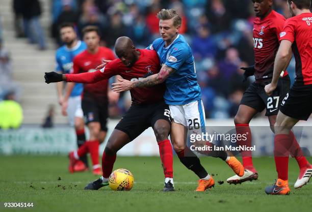 Youssouf Mulumbu of Kilmarnock vies with Jason Cummings of Rangers during the Ladbrokes Scottish Premiership match between Rangers and Kilmarnock at...