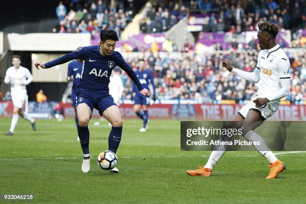 Son Heung-min of Tottenham Hotspur is challenged by Tammy Abraham of Swansea during the Fly Emirates FA Cup Quarter Final match between Swansea City...