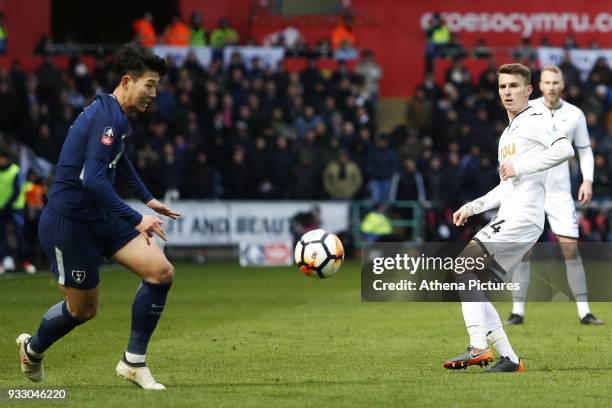 Tom Carroll of Swansea threads a through ball down the win as Son Heung-min of Tottenham Hotspur watches during the Fly Emirates FA Cup Quarter Final...