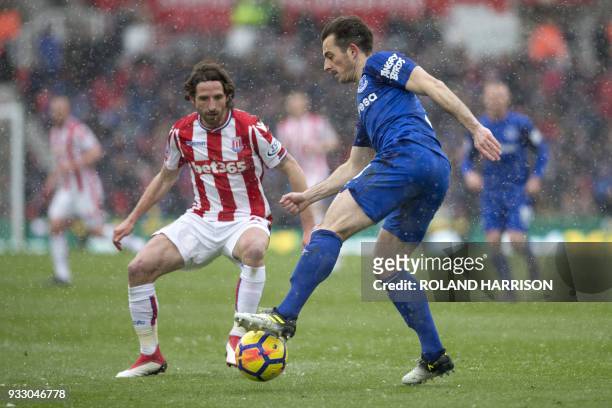 Stoke City's Welsh midfielder Joe Allen vies with Everton's English defender Leighton Baines during the English Premier League football match between...