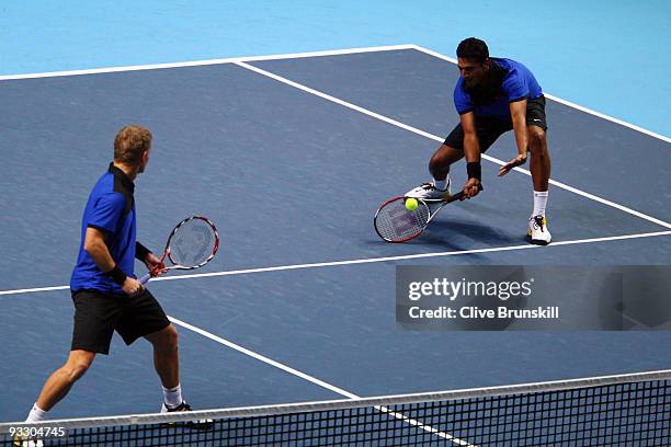 Mahesh Bhupathi of India returns the ball playing with Mark Knowles of The Bahamas during the men's doubles first round match against Frantisek...