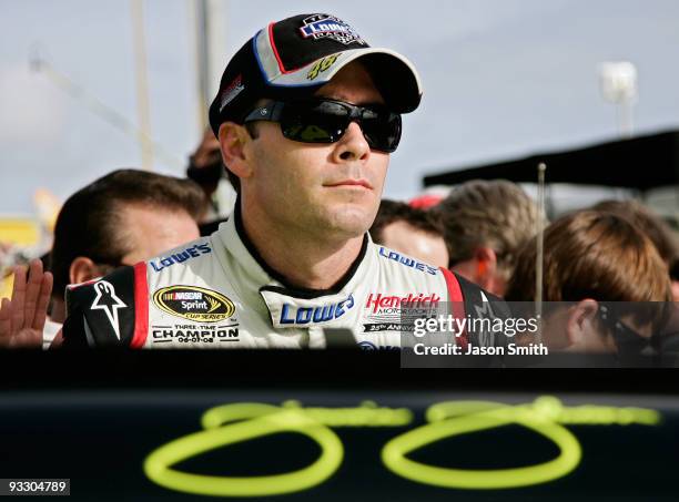 Jimmie Johnson, driver of the Lowe's Chevrolet, stands on the grid prior to the start of the NASCAR Sprint Cup Series Ford 400 at Homestead-Miami...