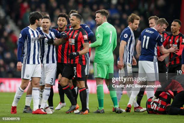 Joshua King and Callum Wilson of Bournemouth with Claudio Yacob of West Bromwich Albion who have to be kept apart after Yacob's challenge on Adam...