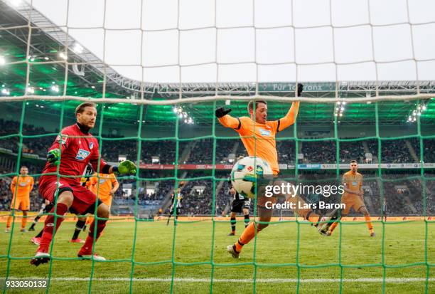 Matthias Ginter of Moenchengladbach scores his teams third goal against Oliver Baumann of Hoffenheim during the Bundesliga match between Borussia...