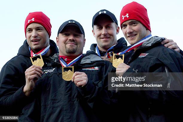 Members of USA 1, Steve Mesler, Steven Holcomb, Curtis Tomasevic and Justin Olsen pose for photographers after winning the 4-man bobsled competition...