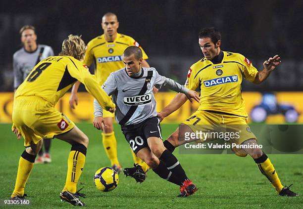 Sebastian Giovinco of Juventus FC is challenged by Gaetano D'agostino and Dusan Basta of Udinese Calcio during the Serie A match between Juventus and...