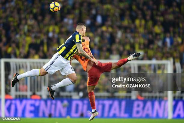 Fenerbahce's defender Martin Skrtel heads the ball next to Galatasaray's midfielder Sofiane Feghouli during Turkish Spor Toto Super league fotball...