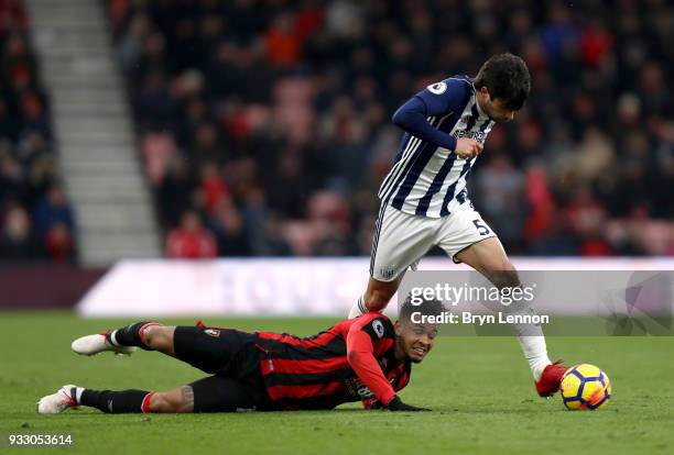 Joshua King of AFC Bournemouth goes down as Claudio Yacob of West Bromwich Albion runs with the ball during the Premier League match between AFC...