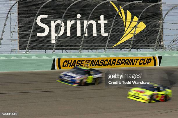 Jimmie Johnson, driver of the Lowe's Chevrolet, races Mark Martin, driver of the Kellogg's/CARQUEST Chevrolet, during the NASCAR Sprint Cup Series...