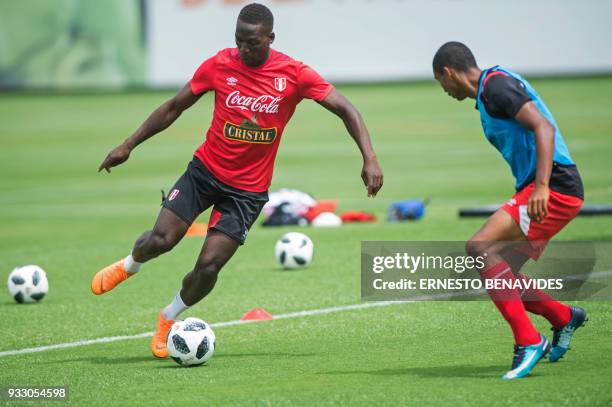 Peruvian national football team player Luis Advincula , runs with the ball during a training session in Lima on March 17 before the team's departure...