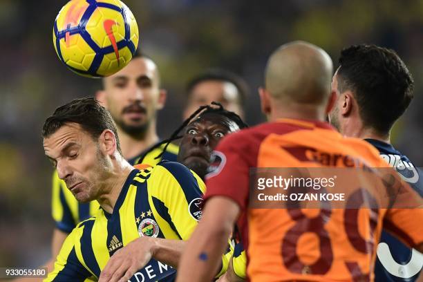 Galatasaray's Bafetimbi Gomis vies for the ball with Fenerbahce's Spanish forward Roberto Solgado during the Turkish Super Lig football match between...