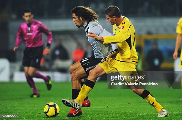 Carvalho De Oliveira Amauri of Juventus FC is challenged by Andrea Coda of Udinese Calcio during the Serie A match between Juventus and Udinese at...