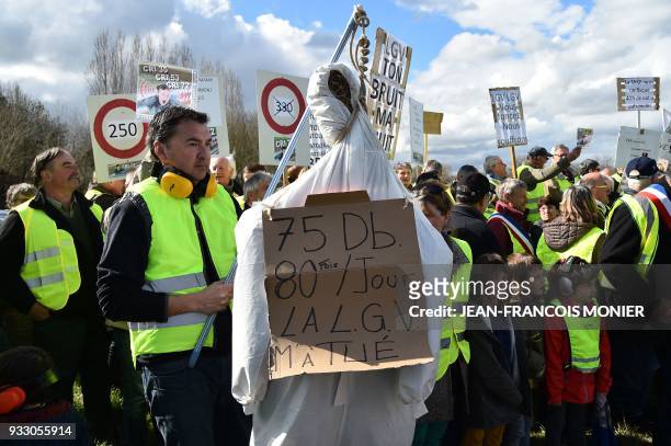 Protester holds a fake hanged man, on which reads "75 DB, 85 times a day, LGV killed me" during a protest against the Ligne A Grande Vitesse between...