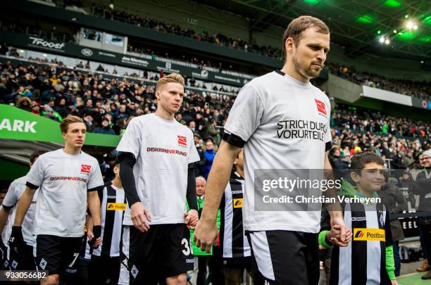 Tony Jantschke, Nico Elvedi and Patrick Herrmann of Borussia Moenchengladbach enter the pitch with mascot kids prior to the Bundesliga match between...