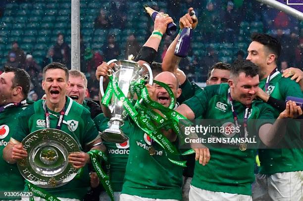 Ireland's hooker Rory Best holds the Six Nations trophy and Ireland's fly-half Jonathan Sexton the Triple Crown as they celebrate their Six Nations...