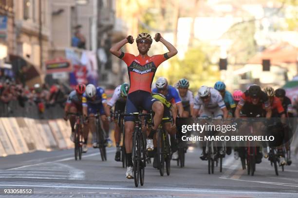 Italy's Vincenzo Nibali of team Bahrain celebrates after crossing the finish line to win the 109th edition of the Milan - San Remo cycling race on...