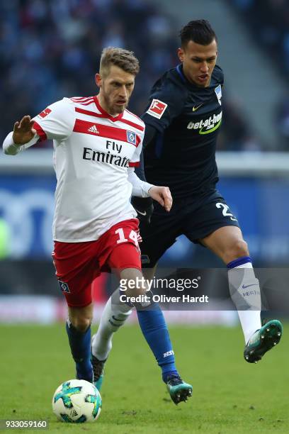 Aaron Hunt of Hamburg and Davie Selke of Berlin compete for the ball during the Bundesliga match between Hamburger SV and Hertha BSC at...