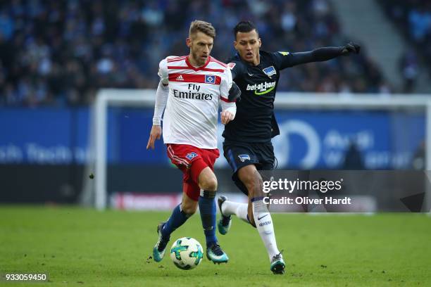 Aaron Hunt of Hamburg and Davie Selke of Berlin compete for the ball during the Bundesliga match between Hamburger SV and Hertha BSC at...