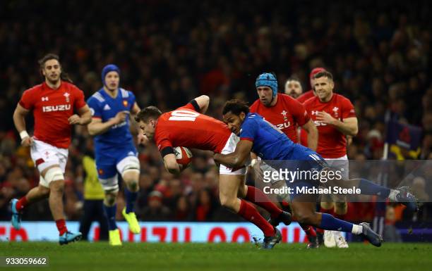 Dan Biggar of Wales is tackled by Benjamin Fall of France during the NatWest Six Nations match between Wales and France at Principality Stadium on...