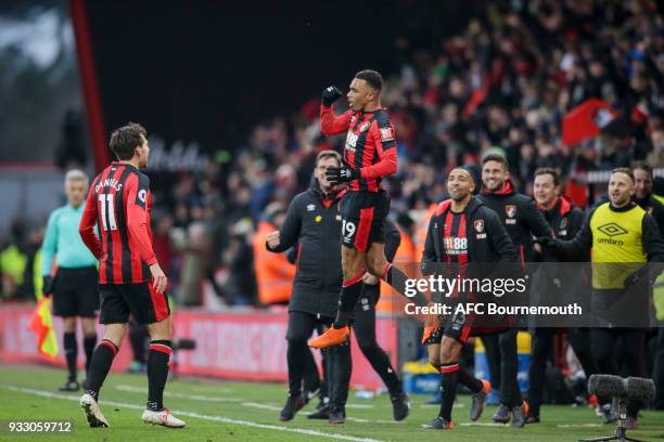 Junior Stanislas of Bournemouth is congratulated by team-mate Charlie Daniels after he scores the winning goal to make it 2-1 during the Premier...