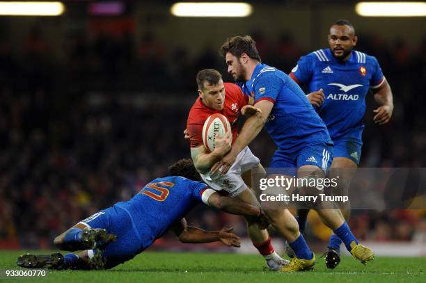 Gareth Davies of Wales is tackled by Benjamin Fall of France and Marco Tauleigne of France during the NatWest Six Nations match between Wales and...