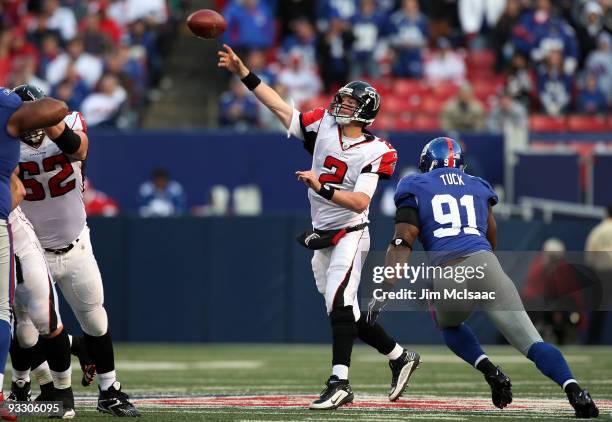 Matt Ryan of the Atlanta Falcons throws a pass under pressure from Justin Tuck of the New York Giants on November 22, 2009 at Giants Stadium in East...