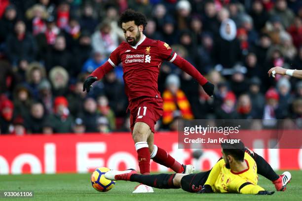 Mohamed Salah of Liverpool goes past Miguel Britos of Watford to score his side's first goal during the Premier League match between Liverpool and...