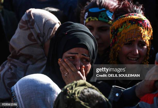 Woman cries during the funeral of People's Protection Units fighters in the northeastern Syrian city of Qamishli on March 17 who were killed while in...