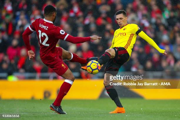 Joe Gomez of Liverpool and Jose Holebas of Watford during the Premier League match between Liverpool and Watford at Anfield on March 17, 2018 in...
