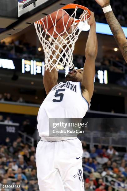 Phil Booth of the Villanova Wildcats dunks the ball against John Petty of the Alabama Crimson Tide during the second half in the second round of the...