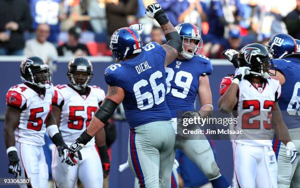 Kevin Boss of the New York Giants celebrates his first touchdown against the Atlanta Falcons with teammate David Diehl on November 22, 2009 at Giants...