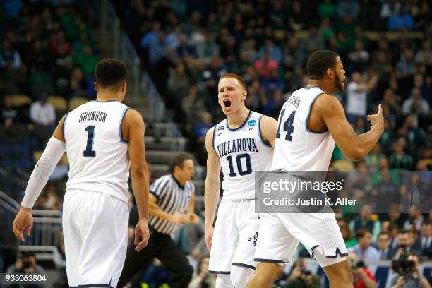 Donte DiVincenzo of the Villanova Wildcats celebrates with his teammates Jalen Brunson and Omari Spellman against the Alabama Crimson Tide during the...