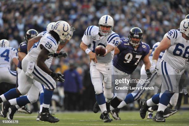 Peyton Manning of the Indianapolis Colts hands off to Joseph Addai during the game against the Baltimore Ravens at M&T Bank Stadium on November 22,...