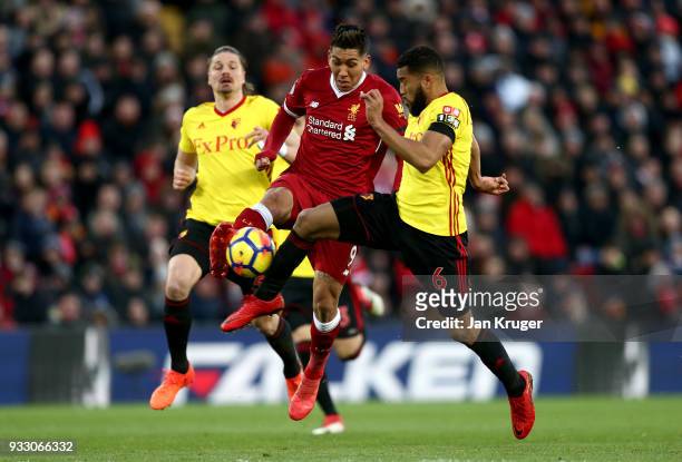 Roberto Firmino of Liverpool and Adrian Mariappa of Watford battle for the ball during the Premier League match between Liverpool and Watford at...