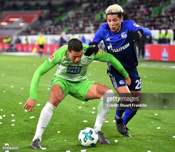 Jeffrey Bruma of Wolfsburg fights for the ball with Amine Harit of Schalke during the Bundesliga match between VfL Wolfsburg and FC Schalke 04 at...