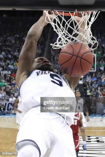 Phil Booth of the Villanova Wildcats dunks the ball against John Petty of the Alabama Crimson Tide during the second half in the second round of the...