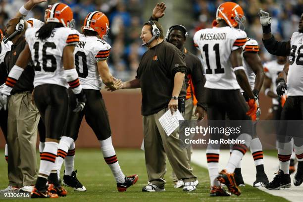 Head coach Eric Mangini of the Cleveland Browns congratulates quarterback Brady Quinn after a touchdown pass against the Detroit Lions at Ford Field...