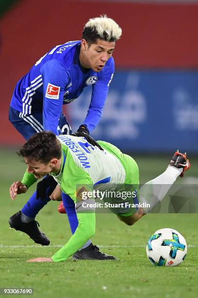 Amine Harit of Schalke and Paul Verhaegh of Wolfsburg fight for the ball during the Bundesliga match between VfL Wolfsburg and FC Schalke 04 at...